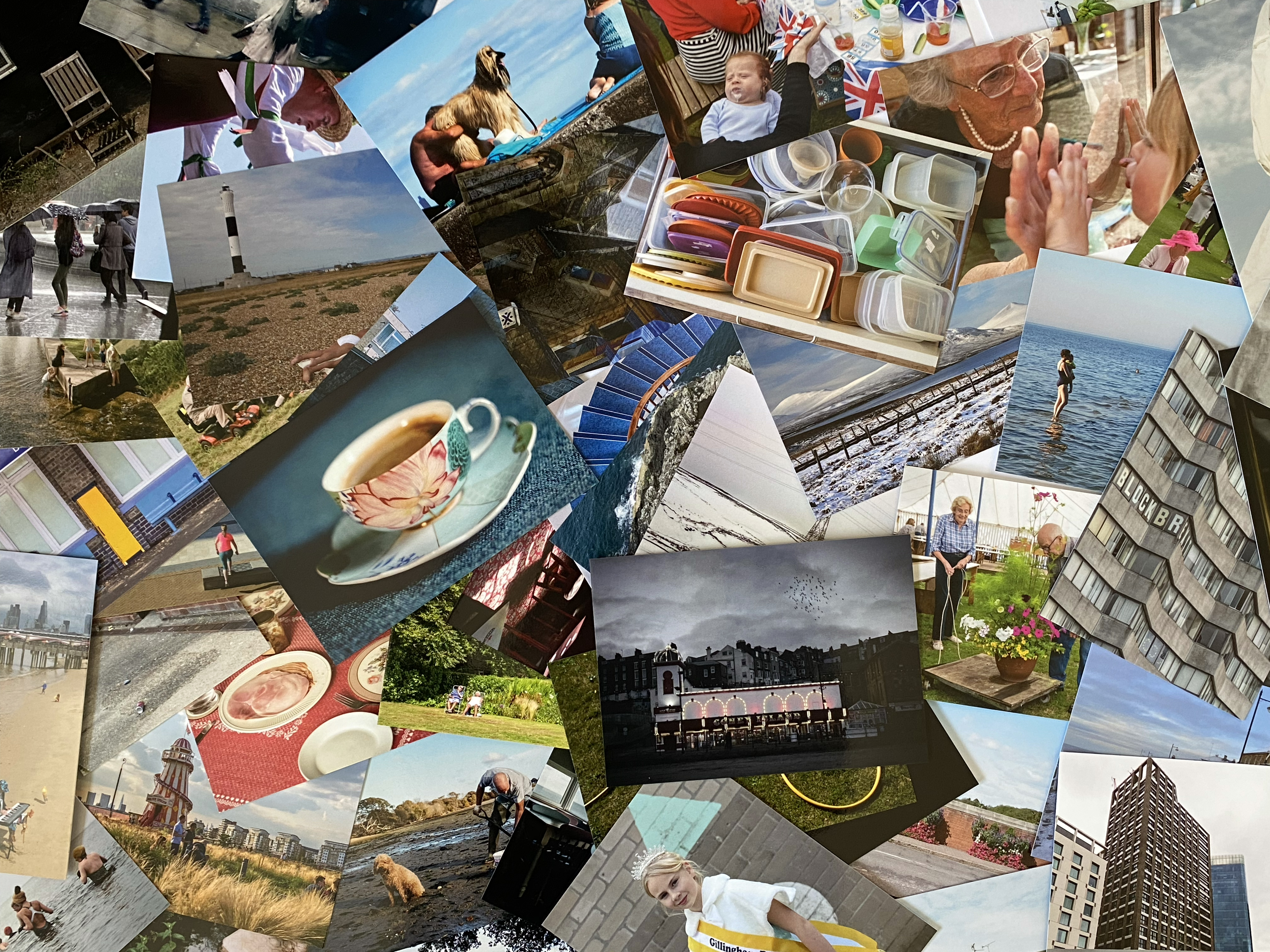 Photograph of a variety of postcards spread out across the image, including a lighthouse on a shingle beach, an ornate cup and saucer of coffee, a dog, a drawer filled with tuppaware, a seaside amusement arcade and blocks of flats