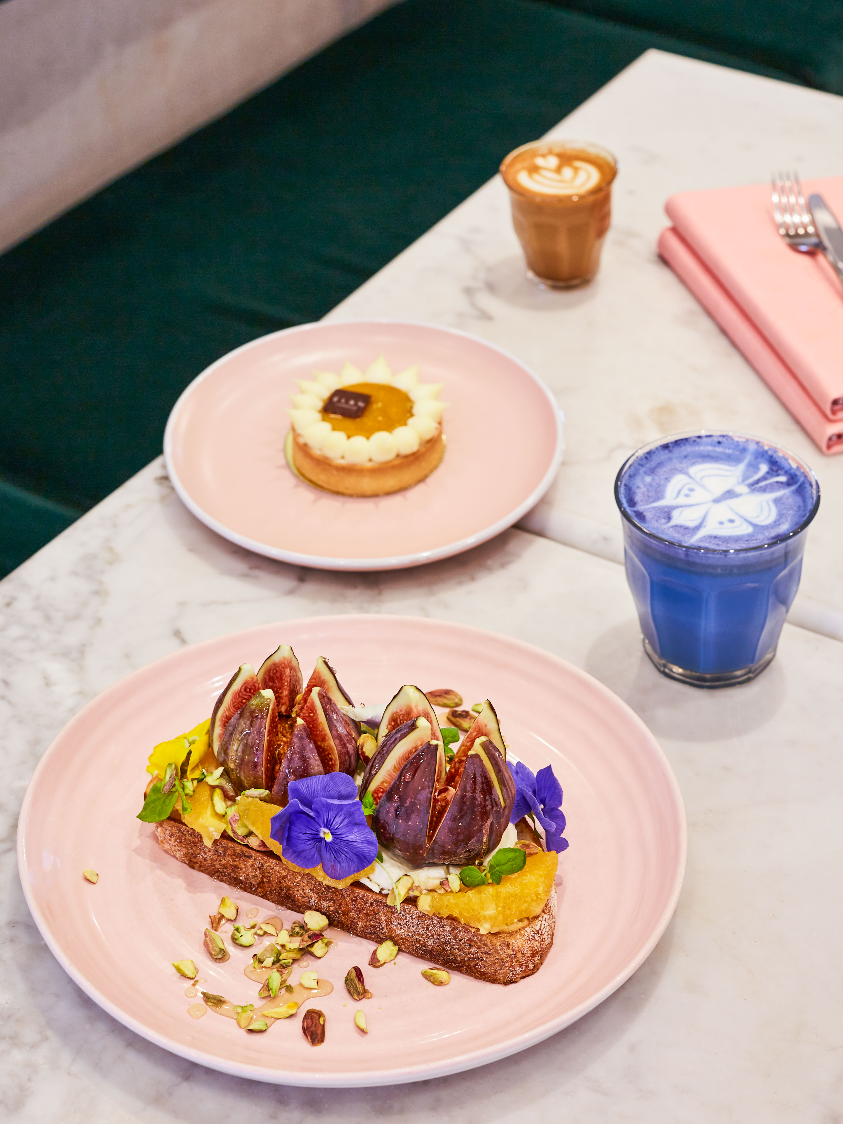 food on pink plates on a marble table
