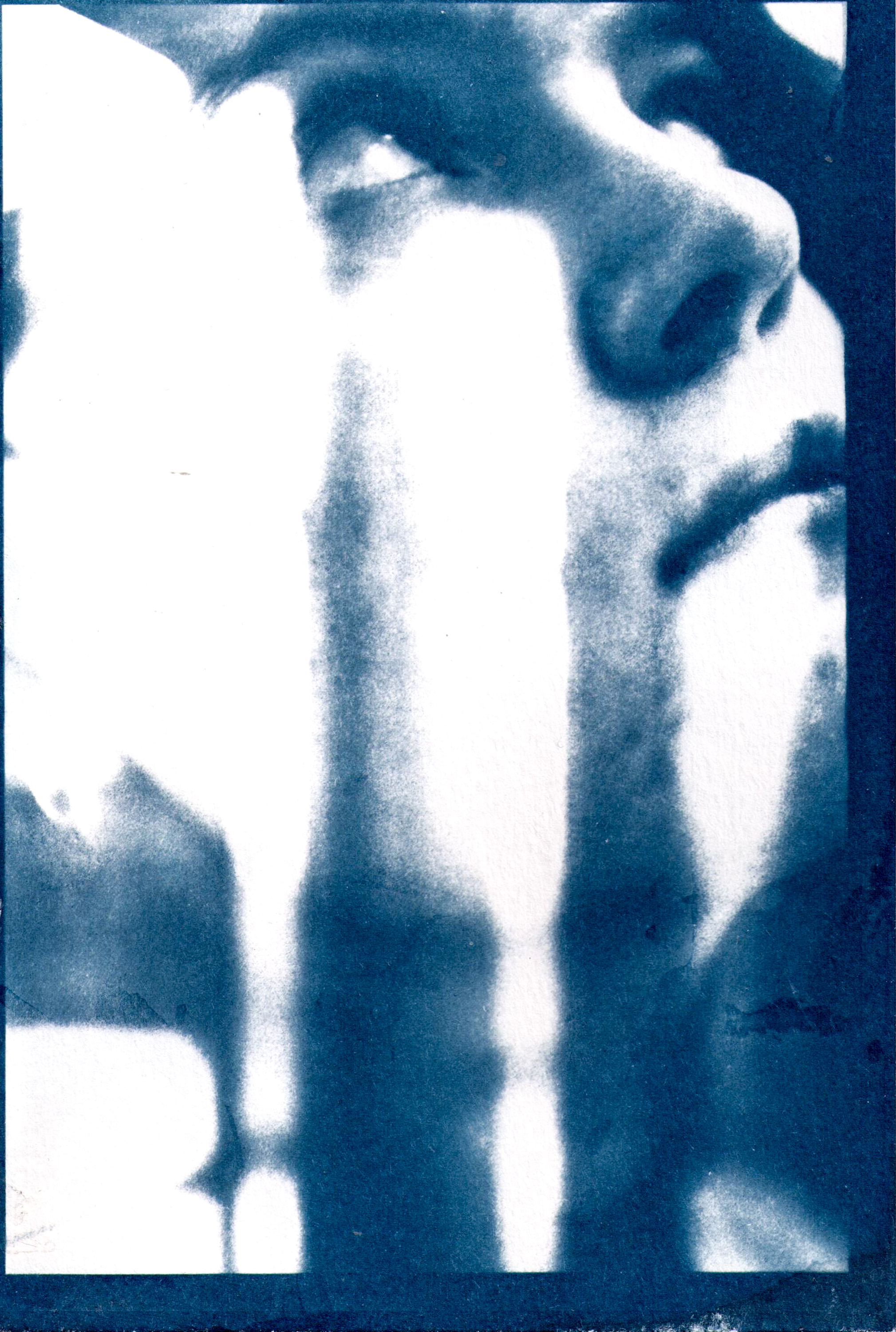 Photo of a female looking up to the top right corner of the photo, her face is close up and windows are double exposed over her face